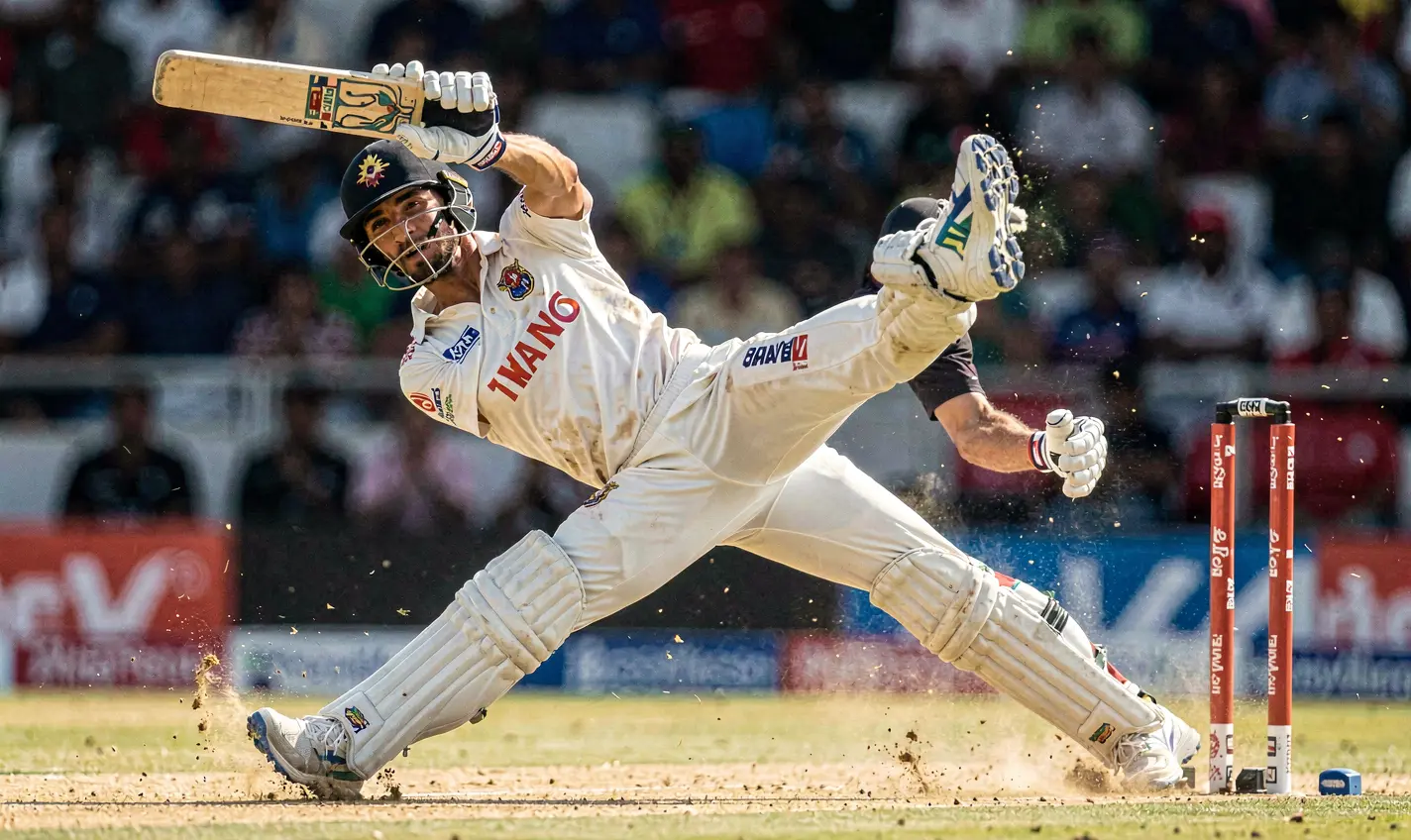 Dramatic slow motion image of a cricket player diving to make a catch showcasing intense match moments available for betting on 32OK in Bangladesh
